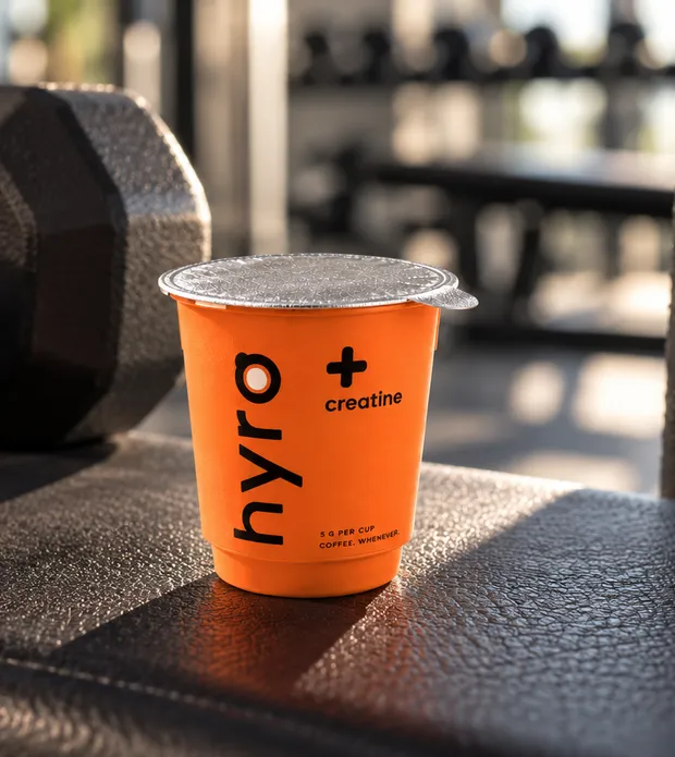 HYRO + Creatine mini cup on a gym bench